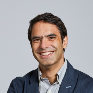 a headshot of Luke Henning, the CEO of BioFluff. Smiling middle-aged man with short brown hair, brown eyes, a shirt and a suit jacket.